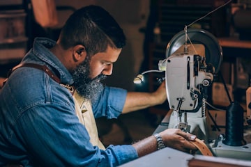 Upholsterer stitching leather